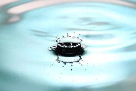 Blue water drops cause the shape. Stock Photos