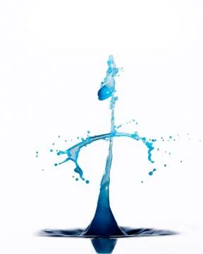 Blue water drops create abstract shape against white background Stock Photos
