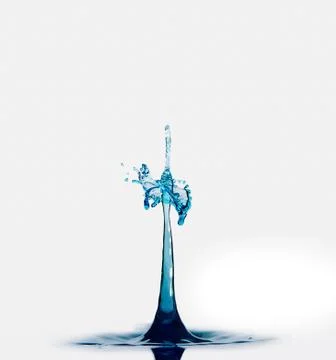 Blue water drops create column and umbrella abstract against white background Stock Photos
