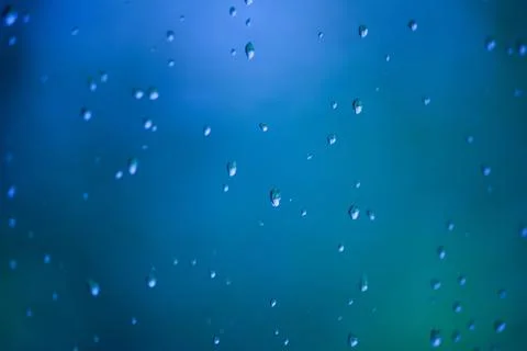 Blue water drops on a window Stock Photos