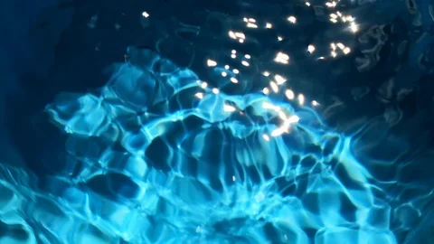 Blue water in fast motion with bright light reflections and waves Stock Footage 96909335