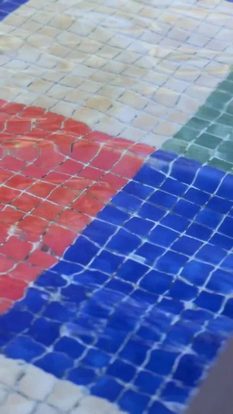 Blue water gently flows in a pool with lush greenery in the background Stock Footage 292922387