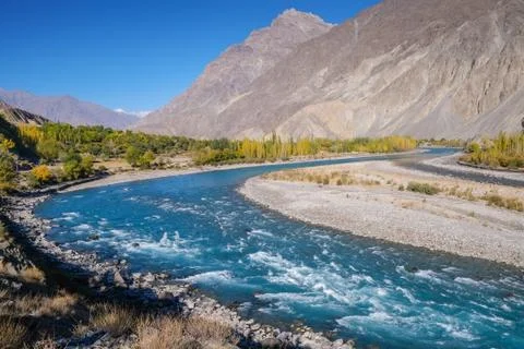 Blue water of Gilgit river flowing through Gupis, Pakistan. Stock Photos