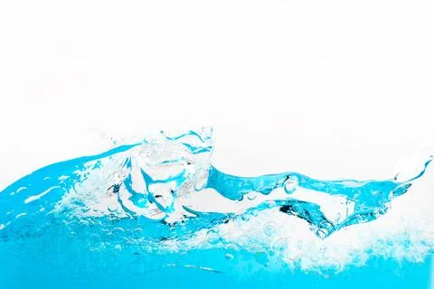Blue water splashing creating bubbles and wave motion Stock Photos