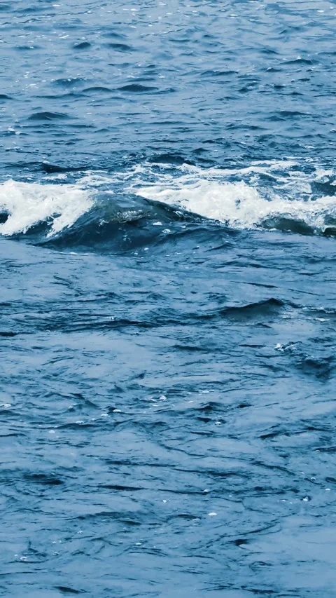 Blue water surface background. Sea waves on the beach. Vertical format. Stock Footage 302900063
