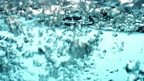 Blue water surface bubbles floating creating dynamic patterns Video stock 329543484