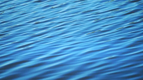 Blue water surface with gentle waves in 4K slow motion, calming abstract natural Stock Footage 325996300