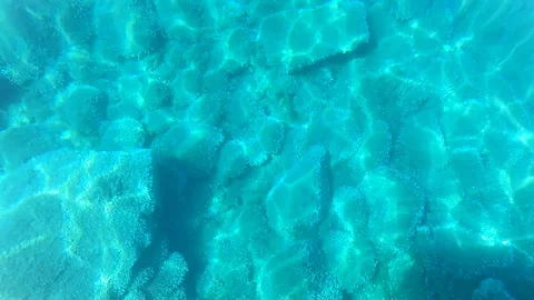Blue Water Surface with Ripple and Stones on a Bottom. Video stock 121777297