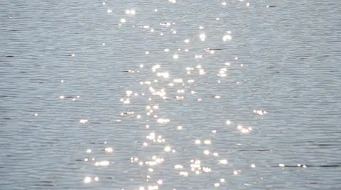 Blue water surface with waves and sparkles glitters in the sun Stock Footage 56100886