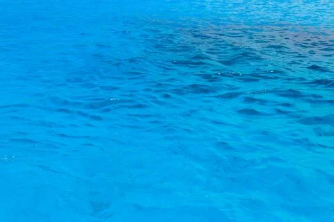 Blue water texture background. Surface of sea or ocean Stock Photos