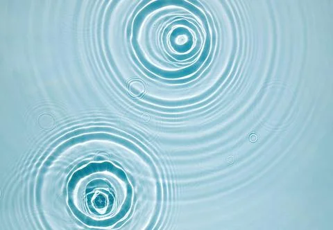Blue water texture, surface with rings, ripples. Spa concept background Stock Photos