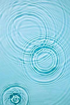 Blue water texture, surface with rings, ripples. Spa concept background Stock Photos