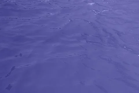Blue water wave texture background. Rippled water. Shiny purple and blue water Stock Photos