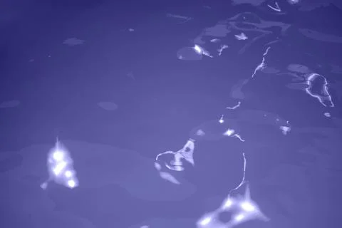 Blue water wave texture background. Rippled water. Shiny purple and blue wate Stock Photos