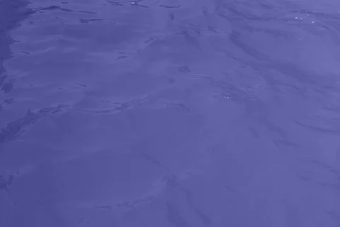 Blue water wave texture background. Rippled water. Shiny purple and blue wate Stock Photos