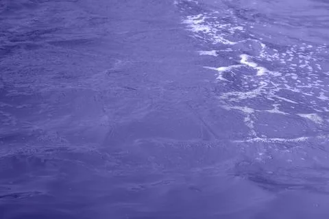 Blue water wave texture background. Rippled water. Shiny purple and blue water Stock Photos