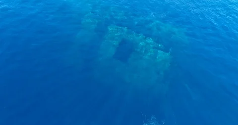 Blue water with wreck under, bubbles from divers coming to the surface Stock Footage 114575306
