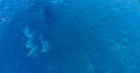 Blue water with wreck under, bubbles from divers and 2 are at the surface Stock Footage 114580387