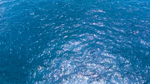 Blue waters of ocean with ripples and reflection of sunlight. Video stock 275567914