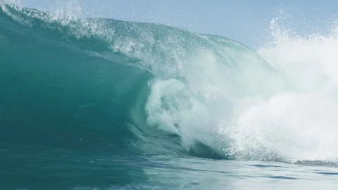 Blue wave breaking destroys itself over very shallow reef 4K Stock Footage 128442820