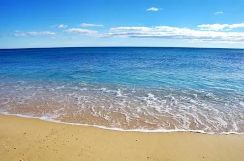 Blue waves on the beach Stock Photos