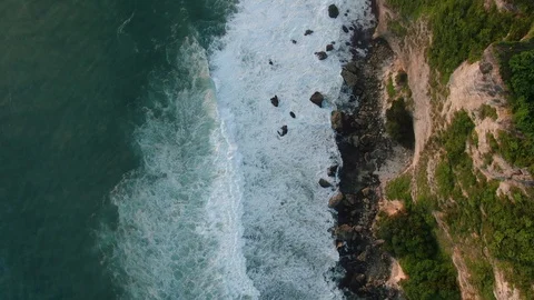 Blue waves in ocean crashing on rock shore. Stock Footage