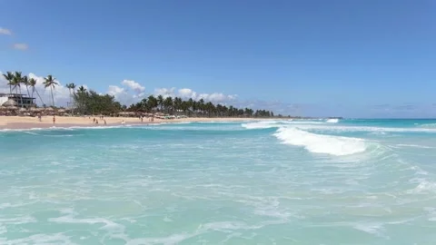 Blue waves of the ocean water at the beach near a resort, tropical vacation, 4k Stock Footage 154803847