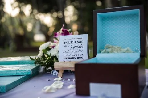 Blue wedding ring box with written quote and flowers Stock Photos