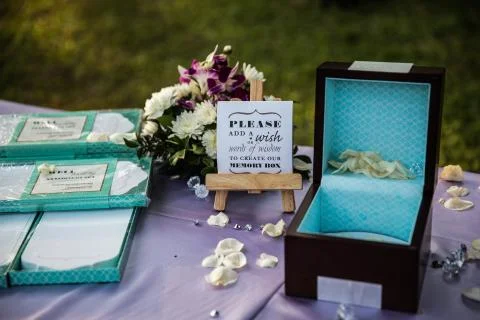 Blue wedding ring box with written quote and flowers Stock Photos