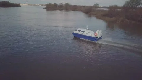 Blue white hovercraft with large propeller sails along river Stock-Footage 155286639