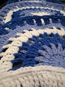 Blue, white round crochet elements and balls of yarn. Crochet texture, place  Stock Photos