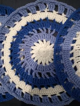 Blue, white round crochet elements and balls of yarn. Crochet texture, place  Stock Photos