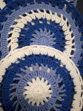 Blue, white round crochet elements and balls of yarn. Crochet texture, place  Stock Photos