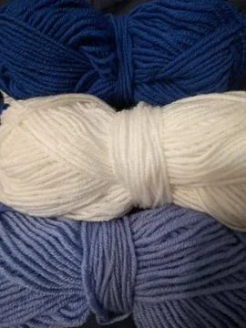 Blue, white round crochet elements and balls of yarn. Crochet texture, place  Stock Photos