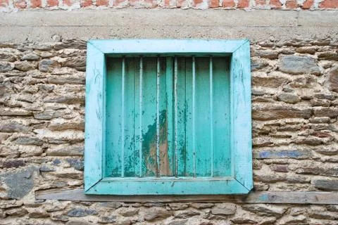 Blue window and shutter on stone brick wall. Stock Photos
