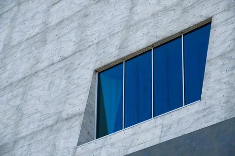 Blue window on a big gray facade Foto stock