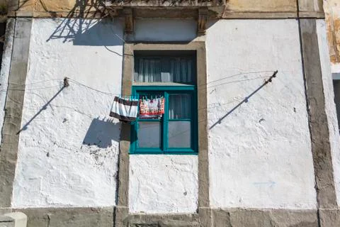 Blue window with clothes drying on the ropes Stock Photos