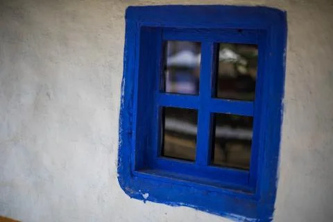 Blue window on an old house Stock Photos