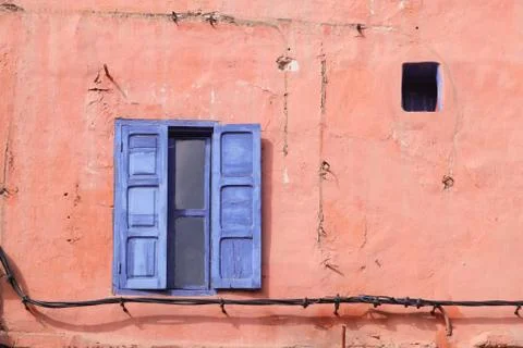 Blue window on the pink wall. Stock Photos