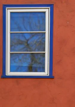 Blue window red stucco Stock Photos