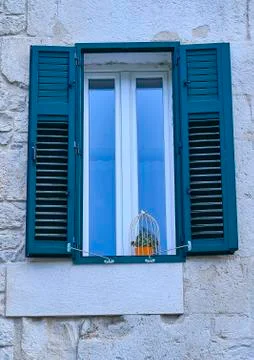 Blue window in a stone wall Stock Photos