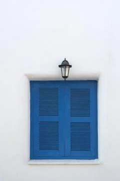 Blue window on the white wall Stock Photos