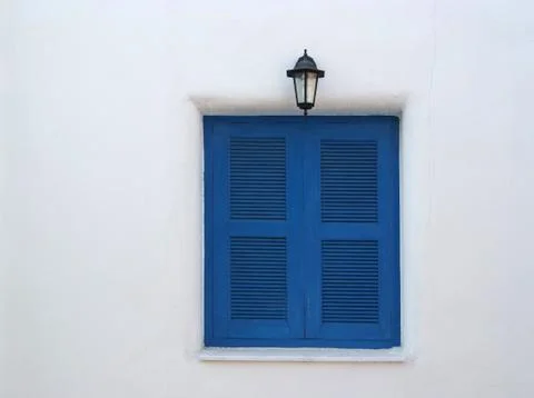 Blue window on the white wall Stock Photos