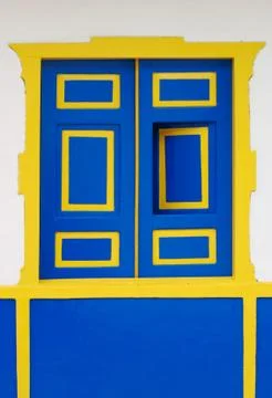 Blue window with yellow frame Stock Photos