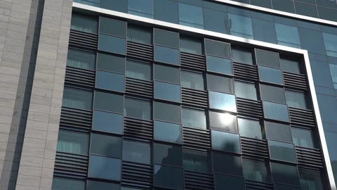 Blue windows office building morning sun Stock Footage