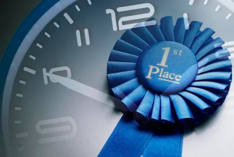 Blue winners rosette on the dial of a clock Stock Photos