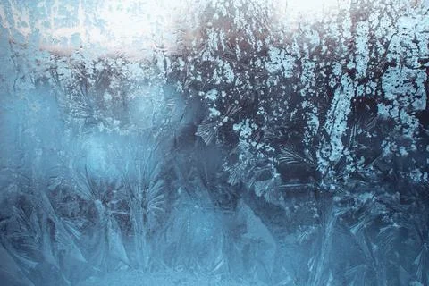 Blue winter background with frost pattern on the window. Beautiful frosty  Stock Photos