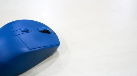 Blue wireless mouse on the table, silent click Stock Photos