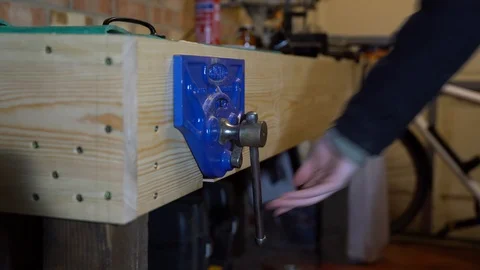Blue woodworking vise being opened slowly by hand Stock Footage 85488276