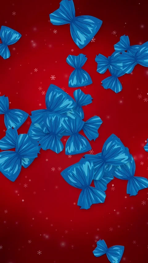 Blue Wrapped Candies Falling Over Red Background with Snowflakes Stock Footage 345307936
